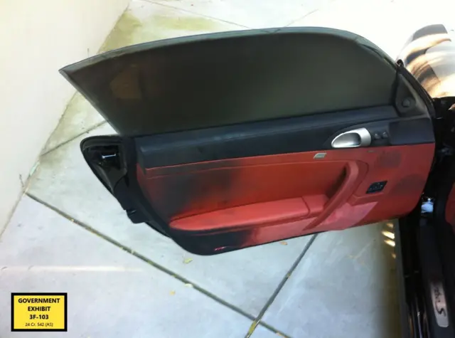 An open car door with red inlay and extensive black burn marks
