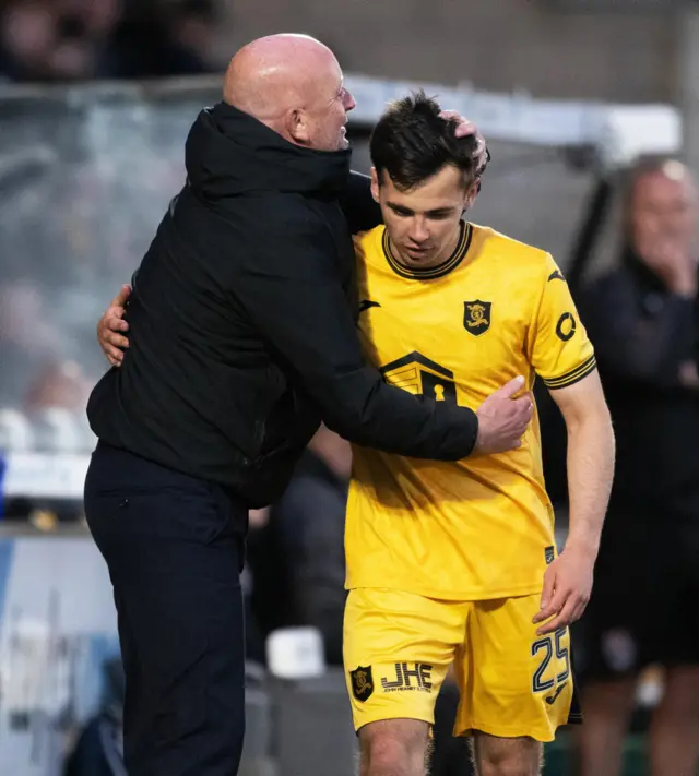 Macaulay Tait gets a cuddle from David Martindale