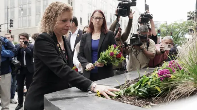 US Representative Debbie Wasserman Schultz (D-FL) pays respects with flowers at the Capital Jewish Museum, near the site where two Israeli embassy staff were shot dead.