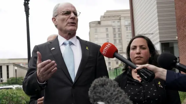 Yechiel Leiter speaking to reporters