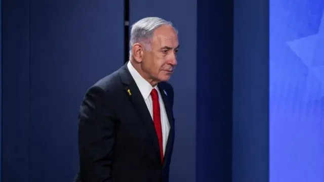 A file photo of Israeli Prime Minister Benjamin Netanyahu - he is photographed side on walking while wearing a suit