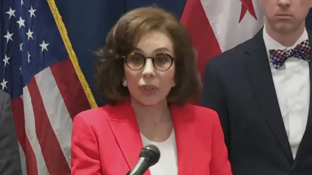 Pirro speaks at the microphone