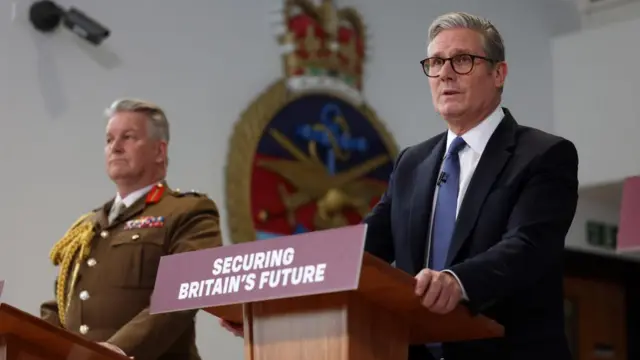 British Prime Minister Keir Starmer (R), accompanied by General Sir Jim Hockenhull (L), speaks during a press conference at Northwood military base in west London