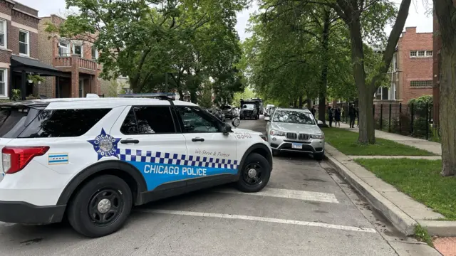 Police car parked blocking residential street