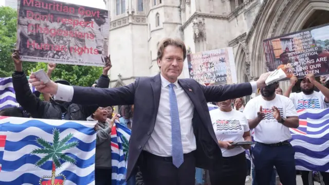 Reform UK deputy leader Richard Tice tears up a copy of the deal over the Chagos Islands in front of protesters outside the High Court