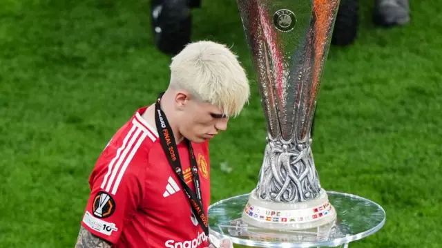 Alejandro Garnacho walks past the Europa League trophy after Manchester United lose the 2025 final to Tottenham