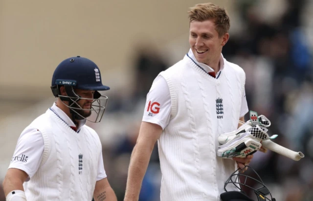 England's Zak Crawley and Ben Duckett walk on