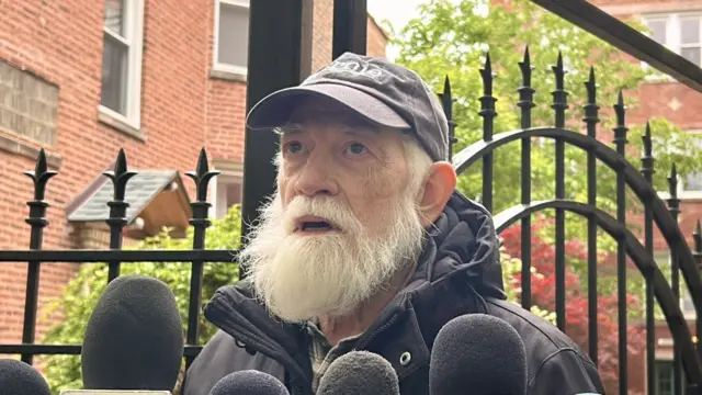 John Wayne Fry speaking in to microphones