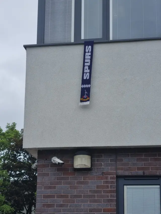 An image of a doctors surgery in Salford with a Spurs flag hanging outside.