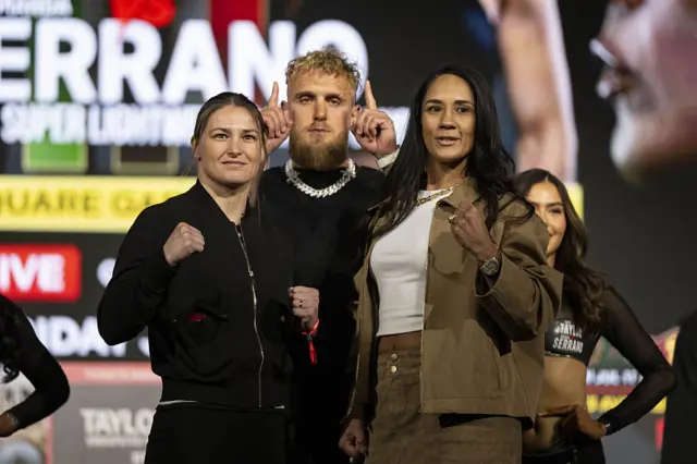 Katie Taylor facing off with Amanda Serrano and Jake Paul is in the middle of them