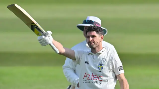 Colin Ackermann raises his bat to the crowd