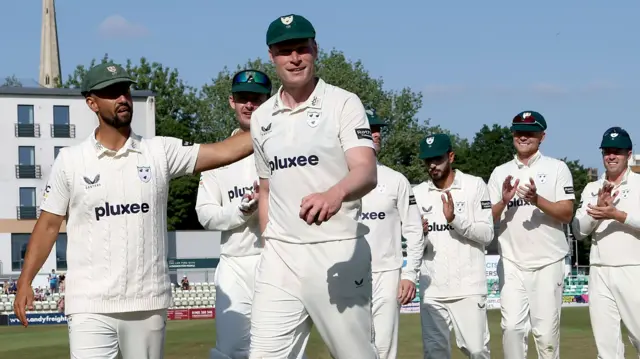 Matthew Waite leads Worcestershire off the field after taking career-best figures against Essex