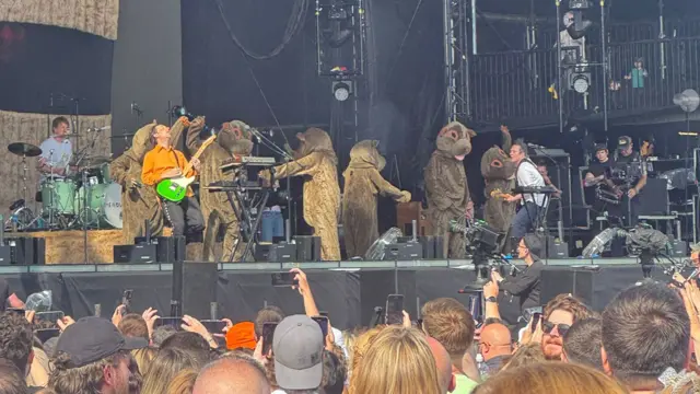 Dancers dressed as wombats move about on the Main Stage at Radio 1's Big Weekend