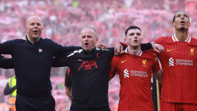 Liverpool manager Arne Slot celebrates the team's Premier League title win with staff and players in 2025