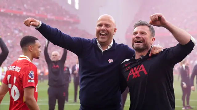 Liverpool manager Arne Slot and head of rehab physiotherapy Lee Nobes celebrate winning the 2024-25 Premier League title