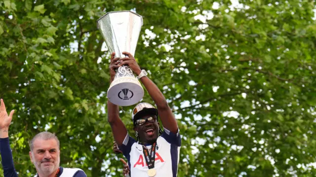 Yves Bissouma raised the Europa League trophy alongside manager Ange Postecoglou with the trophy on the open-top team bus