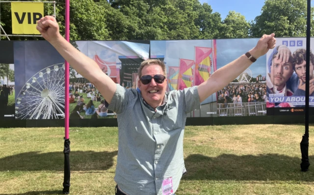 Gary with arms up in the air at Big Weekend.