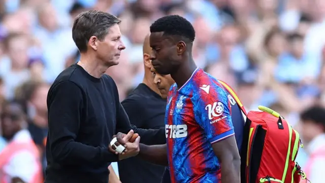 Crystal Palace manager Oliver Glasner shakes hands with Marc Guehi as the defender is substituted during the 2025 FA Cup final