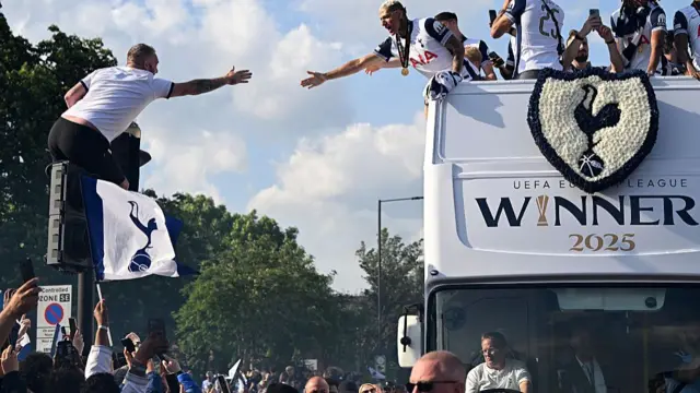 Richarlison of Tottenham Hotspur high-fives a fan during the Tottenham Hotspur UEFA Europa League trophy parade