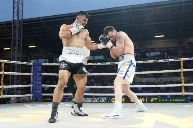 Taz Nadeem lands an uppercut on Bahadur Karami