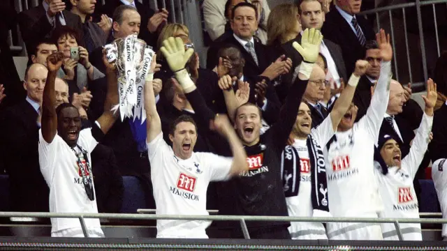 Tottenham Hotspurs' Irish striker Robbie Keane (2nd L, front) and English defender Ledley King (L, front) lift the trophy after winning the Carling Cup Final