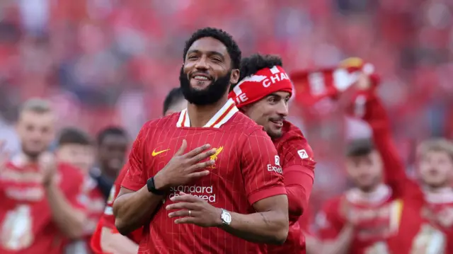 Joe Gomez smiles as he celebrates Liverpool winning the 2024-25 Premier League title with Curtis Jones