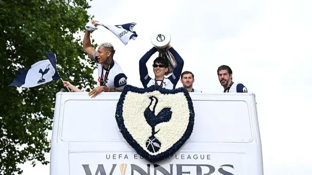 Tottenham Hotspur's South Korean forward #07 Son Heung-Min holds the Europa League trophy during an open-top bus parade
