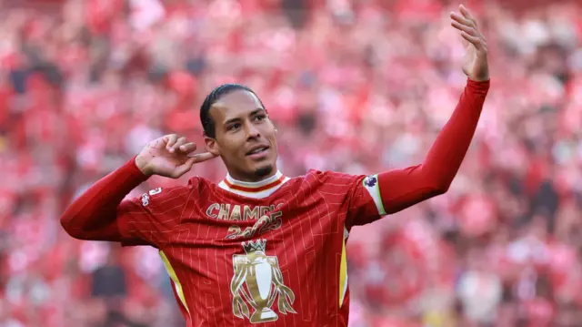 Virgil van Dijk signals for Liverpool fans to sing louder as they celebrate winning the 2024-25 Premier League title