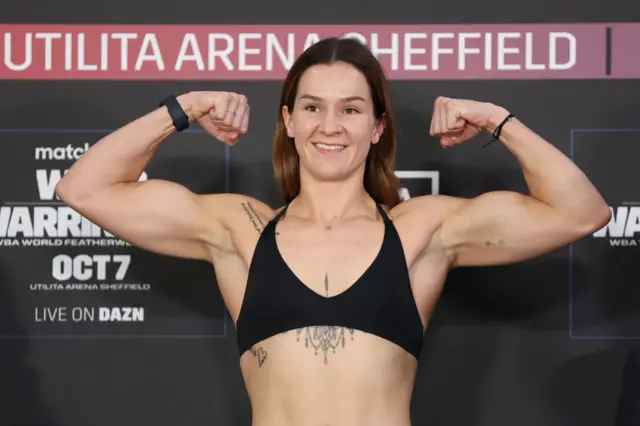 Terri Harper flexing her biceps at the weigh-in