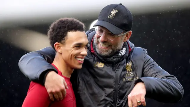 Liverpool manager Jurgen Klopp with his arm around right-back Trent Alexander-Arnold