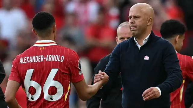 Trent Alexander-Arnold shakes hands with Arne Slot