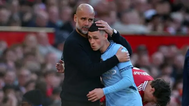 Pep Guardiola hugs Phil Foden