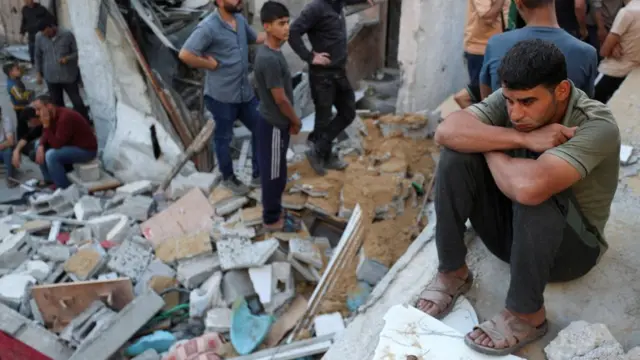 Palestinians gather at the site of an air strike in Jabalia in the northern Gaza.