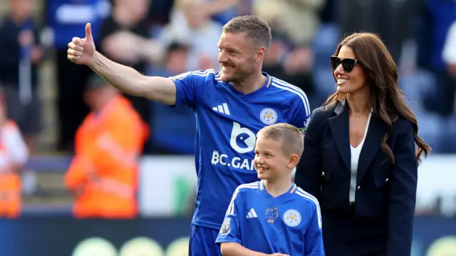 Jamie Vardy waves goodbye to Leicester fans with his family on the field