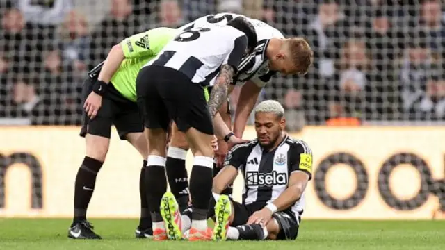Joelinton of Newcastle United is consoled by team-mates Dan Burn and Sandro Tonali