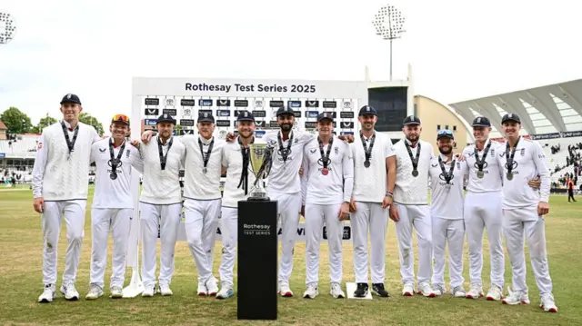 England's players pose with the trophy.