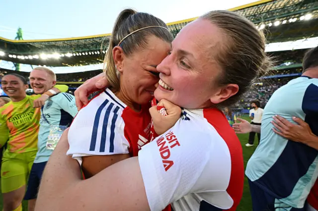 Katie McCabe and Kim Little of Arsenal embrace as they celebrate victory