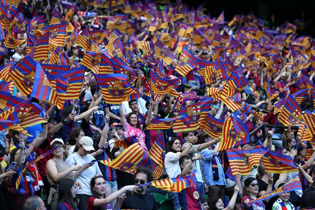 Barcelona fans wave flags in the stands