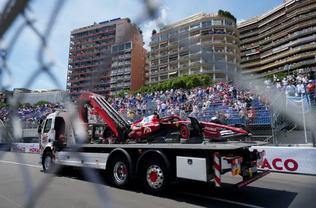 Lewis Hamilton's Ferrari is taken away on the recovery truck