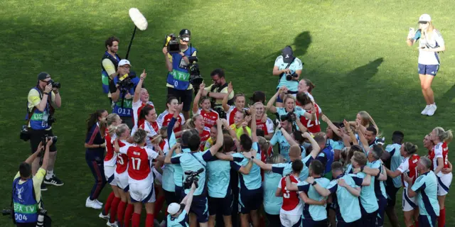 Arsenal players celebrate on the pitch