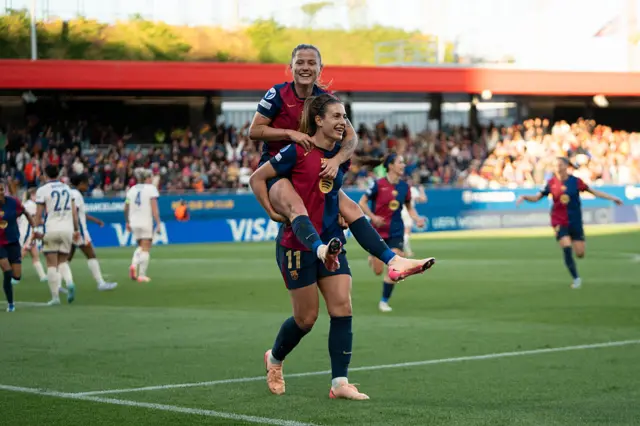 Alexia and Pina celebrate combining for a goal v Chelsea