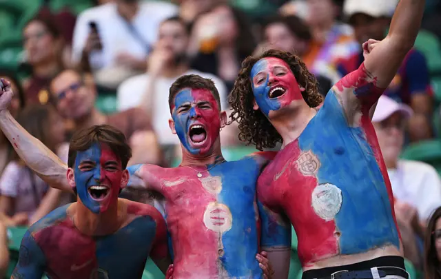 Fans chant in the stands with Body paint to mimic the Barca shirt
