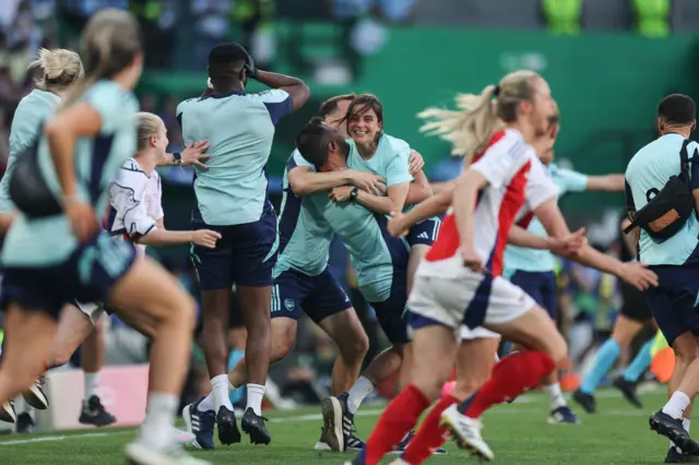 Slegers is lifted into the air as the final whistle goes