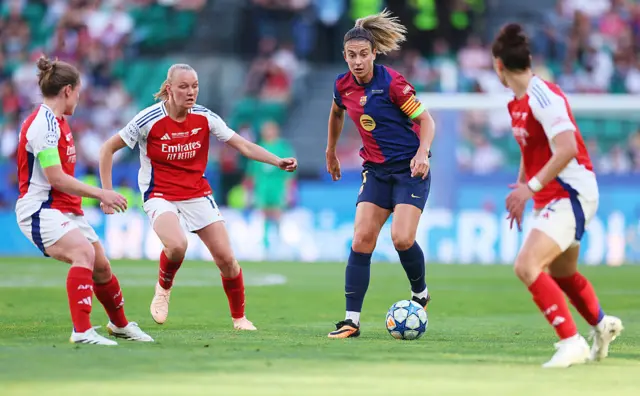 Alexia is surrounded by Arsenal defenders
