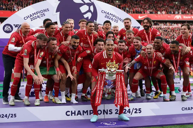 Virgil van Dijk of Liverpool, lifts the Premier League trophy, as Liverpool are crowned the Champions of the Premier League, following the Premier League match between Liverpool FC and Crystal Palace FC at Anfield on May 25, 2025 in Liverpool, England.