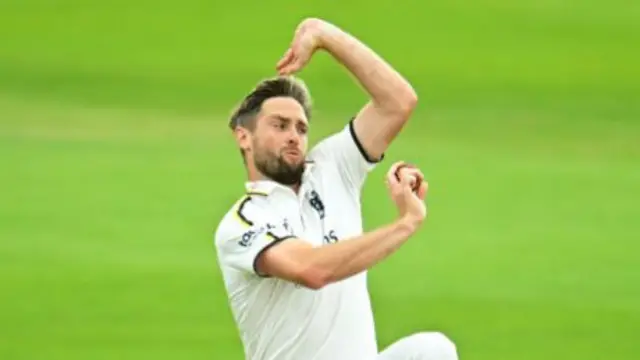 Warwickshire's Chris Woakes runs in to bowl.
