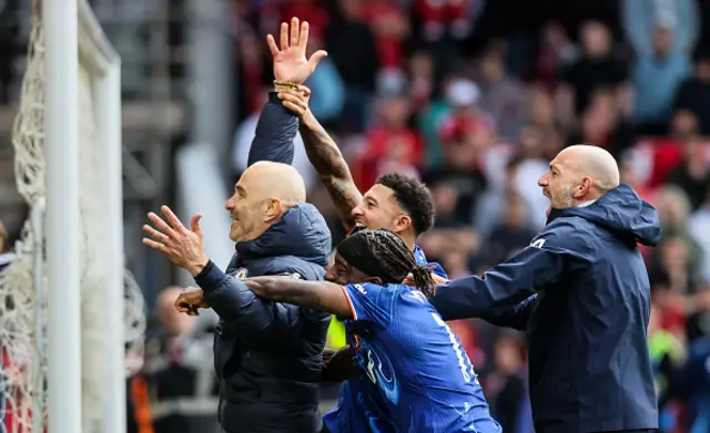 Chelsea's manager Enzo Maresca (left) celebrates qualifying for next season's Champions League with Jadon Sancho and Noni Madueke