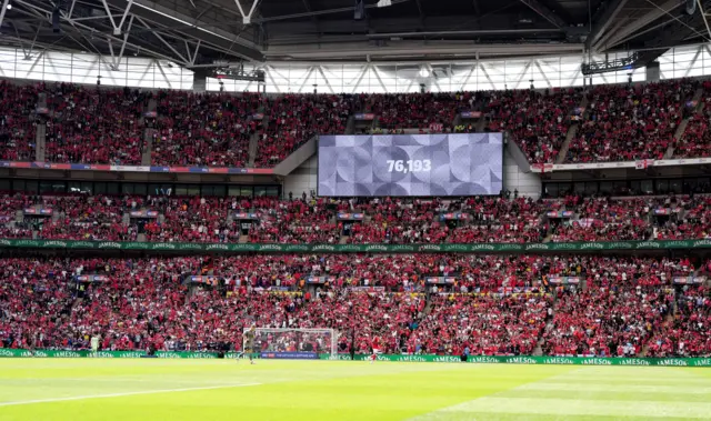 The stadiums big screen displays the match attendance of 76,193