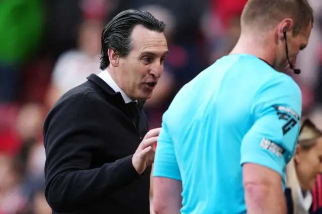 Aston Villa manager Unai Emery (left) speaks to referee Thomas Bramall after the Premier League match at Old Trafford, Manchester