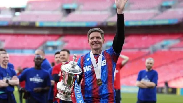 Oliver Glasner carrying the FA Cup trophy